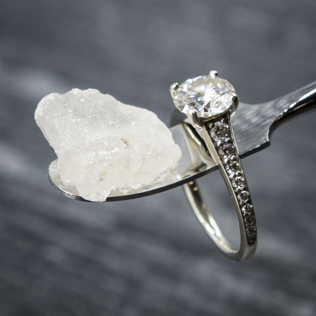 picture of cannabis concentrates in 1 gram glass containers, and a logo in the middle saying "Selling Happiness by the Gram"